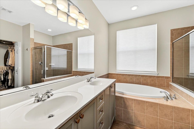 3256 Whitman Way, Tallahassee, FL 32311 - bathroom with a shower stall, a bath, double vanity, and a spacious closet