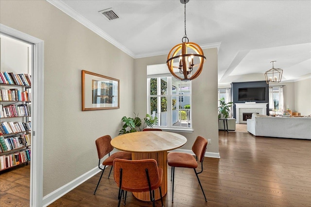 3256 Whitman Way, Tallahassee, FL 32311 - dining space featuring a chandelier, healthy amount of natural light, dark wood finished floors, and crown molding
