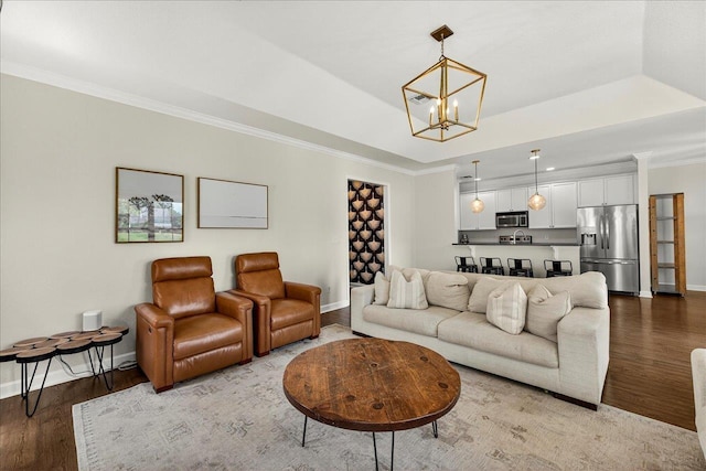 3256 Whitman Way, Tallahassee, FL 32311 - living area featuring wood finished floors, a chandelier, ornamental molding, and a raised ceiling