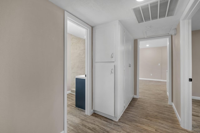 1618 Mayhew St, Tallahassee, FL 32304 - corridor with attic access, baseboards, light wood-style flooring, and visible vents
