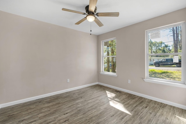 1618 Mayhew St, Tallahassee, FL 32304 - unfurnished room with ceiling fan, baseboards, and wood finished floors