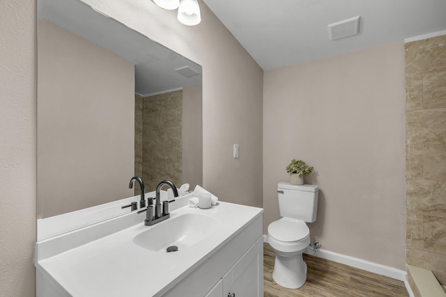 1618 Mayhew St, Tallahassee, FL 32304 - full bathroom featuring wood finished floors, visible vents, toilet, vanity, and baseboards