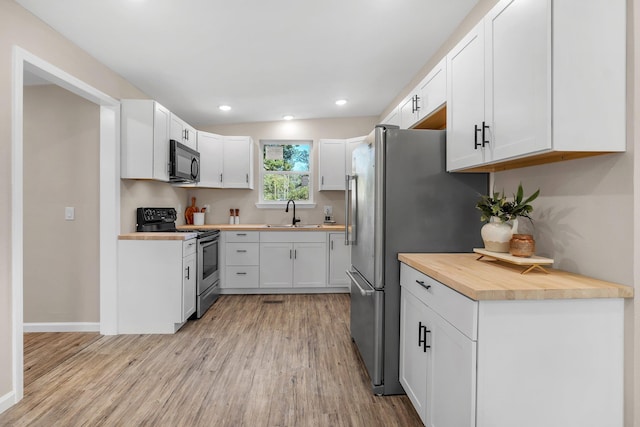 1618 Mayhew St, Tallahassee, FL 32304 - unfurnished living room with baseboards, recessed lighting, and light wood-style floors