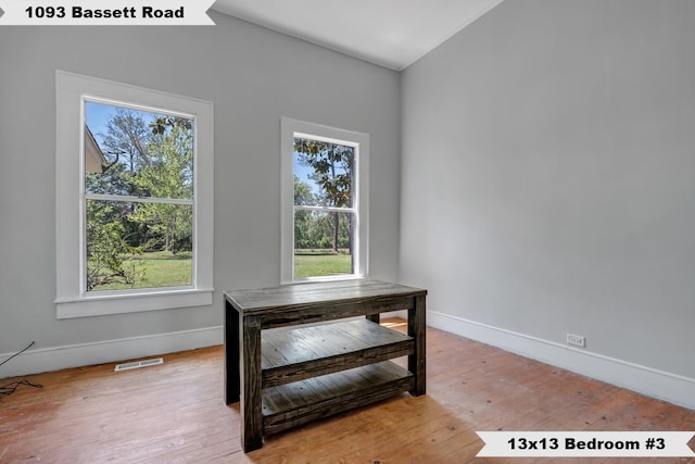 dining space featuring wood-type flooring, visible vents, and baseboards