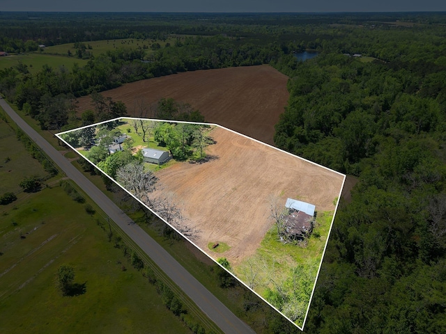 birds eye view of property with a wooded view and a rural view
