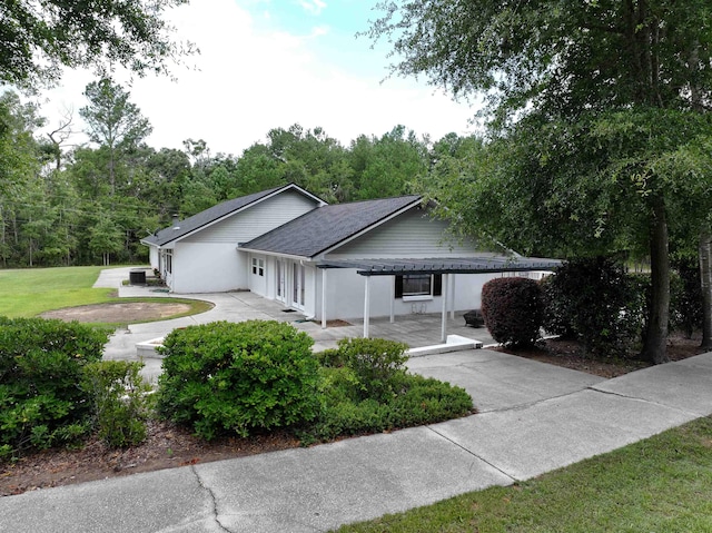 view of front of home with a patio area, a front lawn, and cooling unit