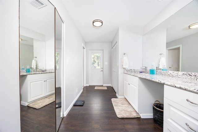 interior space with vanity and hardwood / wood-style flooring