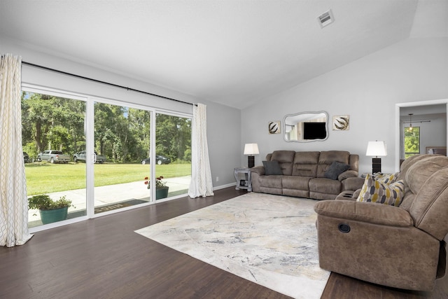 living room featuring dark hardwood / wood-style flooring and vaulted ceiling