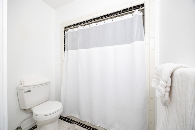 bathroom featuring tile patterned flooring and toilet