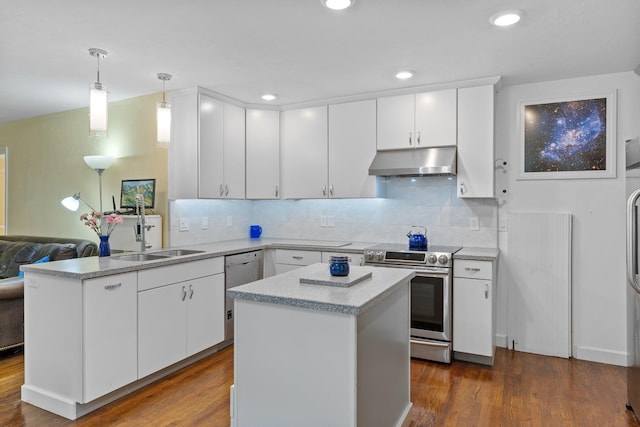 kitchen featuring appliances with stainless steel finishes, white cabinetry, sink, hanging light fixtures, and a center island