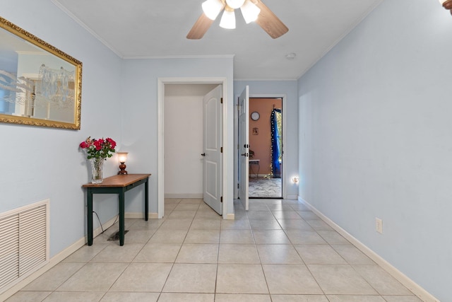 hallway featuring crown molding and light tile patterned floors