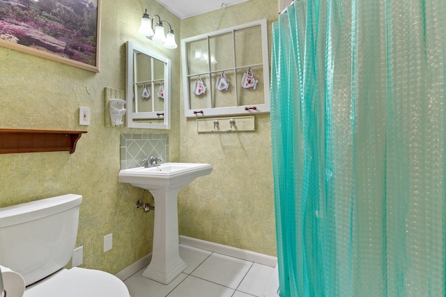 bathroom featuring tile patterned flooring, walk in shower, and toilet