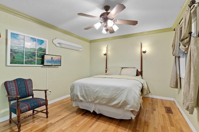 bedroom with light hardwood / wood-style flooring, ornamental molding, and ceiling fan