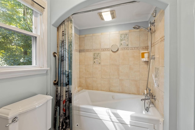 bathroom with crown molding, shower / bath combination with curtain, and toilet