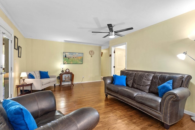 living room with wood-type flooring and ceiling fan