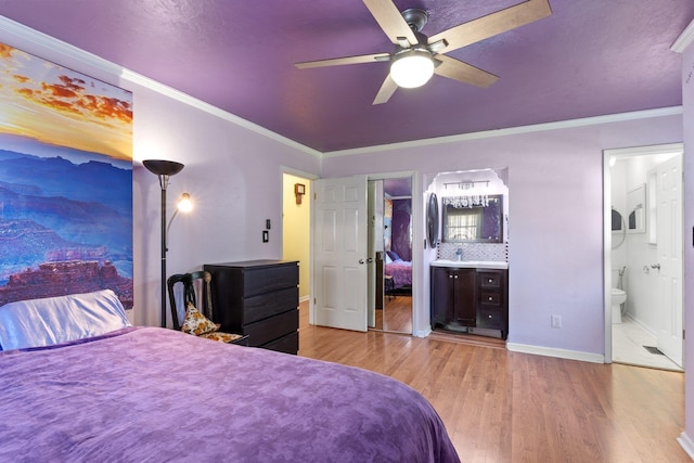 bedroom with connected bathroom, ornamental molding, light hardwood / wood-style floors, and ceiling fan