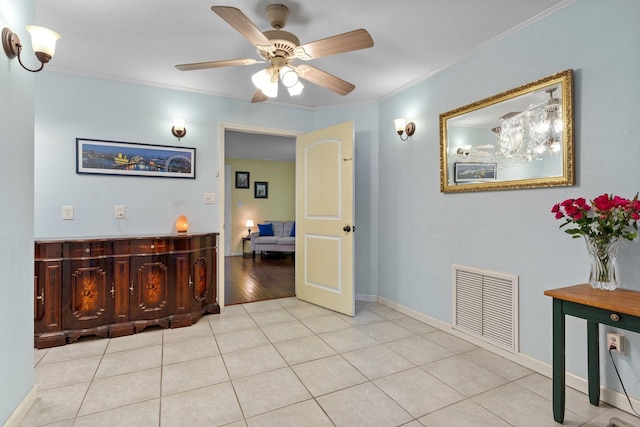 hallway with crown molding and light tile patterned floors