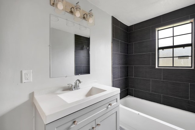 bathroom with vanity and tiled shower / bath combo