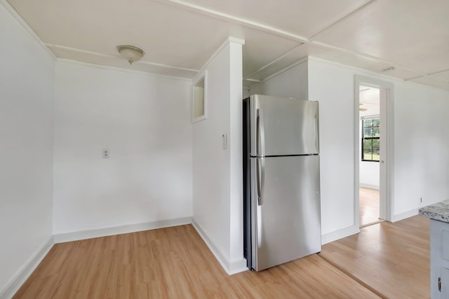 kitchen with stainless steel refrigerator and light hardwood / wood-style flooring