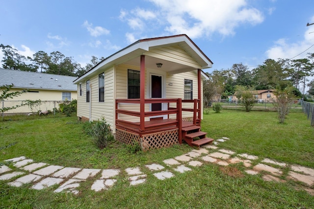 view of front of house with a wooden deck and a front yard