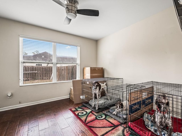 misc room with dark wood-type flooring and ceiling fan