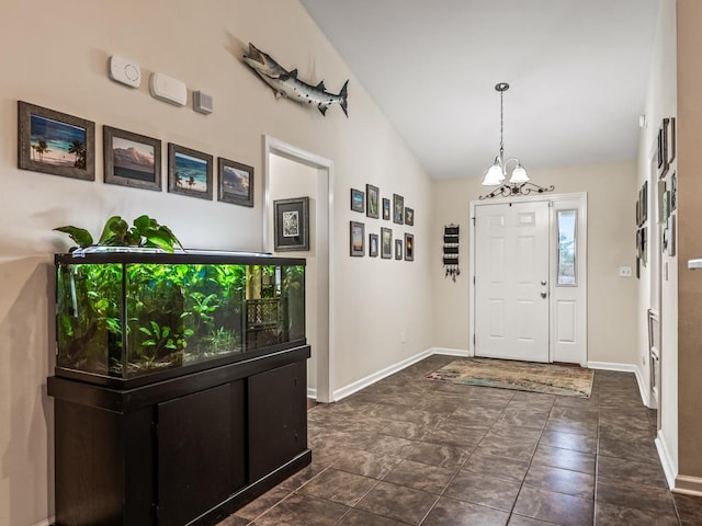entrance foyer with a notable chandelier and vaulted ceiling