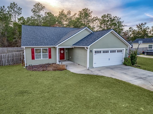 ranch-style house with a garage and a lawn