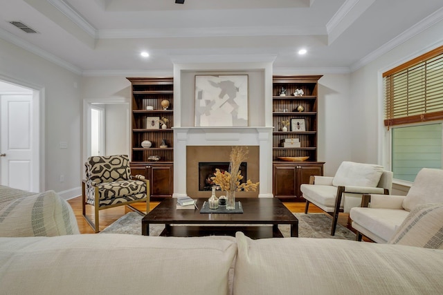 3574 Strolling Way, Tallahassee, FL 32311 - living room featuring wood finished floors, ornamental molding, a fireplace, a tray ceiling, and recessed lighting