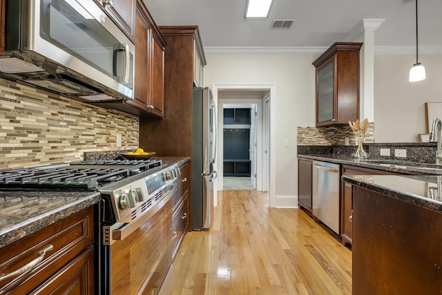 3574 Strolling Way, Tallahassee, FL 32311 - kitchen with stainless steel appliances, ornamental molding, light wood-type flooring, decorative backsplash, and dark stone countertops