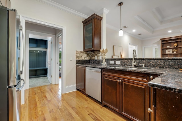 3574 Strolling Way, Tallahassee, FL 32311 - kitchen with appliances with stainless steel finishes, ornamental molding, light wood-style floors, pendant lighting, and glass insert cabinets