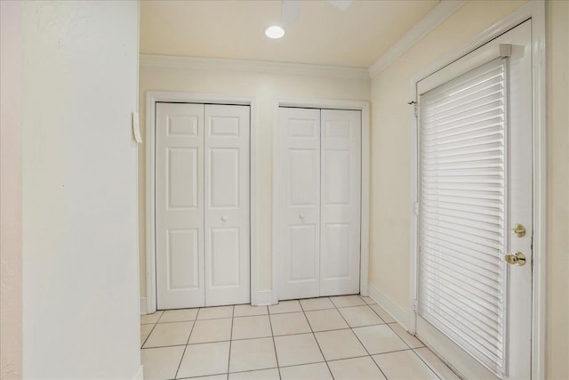 1816 Atlantis Pl, Tallahassee, FL 32303 - unfurnished bedroom with two closets, light tile patterned floors, crown molding, and baseboards
