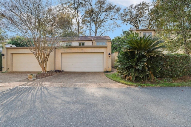 1816 Atlantis Pl, Tallahassee, FL 32303 - view of front of house featuring driveway, stucco siding, and a garage