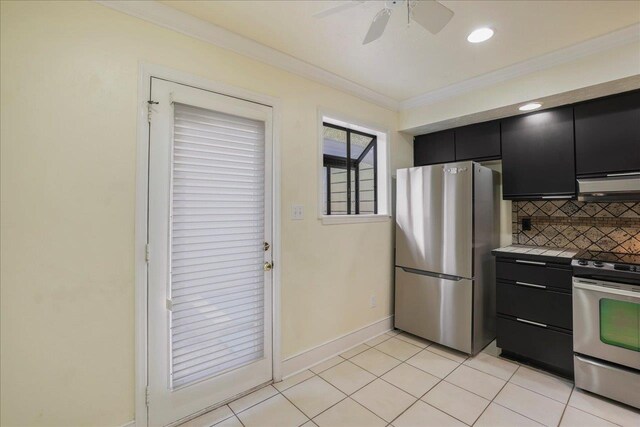 1816 Atlantis Pl, Tallahassee, FL 32303 - kitchen featuring crown molding, dark cabinets, appliances with stainless steel finishes, and decorative backsplash