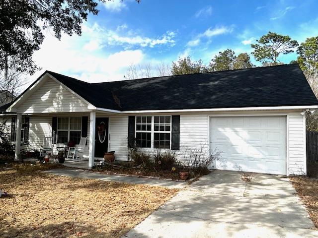 ranch-style home with a porch and a garage