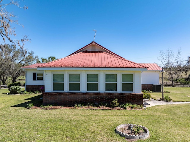 511 SW Sundown Creek Rd, Madison, FL 32340 - view of side of property with brick siding, central AC, and metal roof