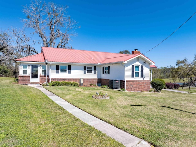511 SW Sundown Creek Rd, Madison, FL 32340 - single story home featuring brick siding, a chimney, central AC unit, and a front yard