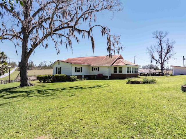 511 SW Sundown Creek Rd, Madison, FL 32340 - rear view of property featuring a lawn and metal roof