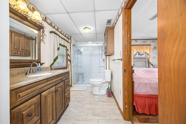 511 SW Sundown Creek Rd, Madison, FL 32340 - bathroom with connected bathroom, vanity, a stall shower, a drop ceiling, and toilet