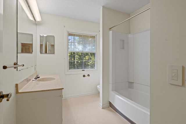 full bathroom featuring toilet, washtub / shower combination, vanity, and a textured ceiling