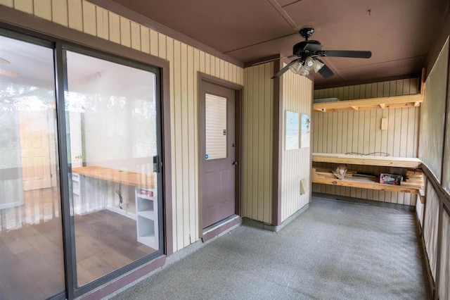 interior space with ceiling fan