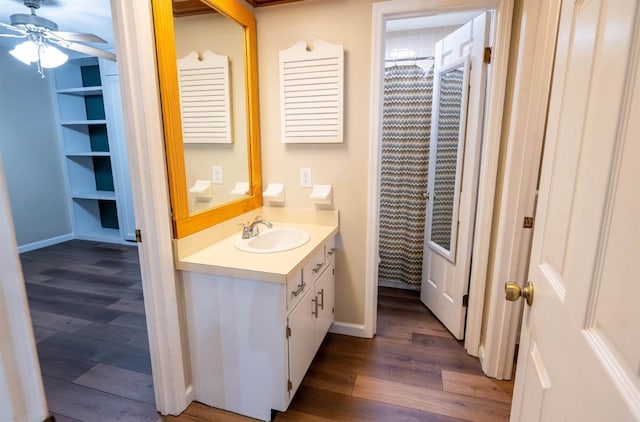 bathroom featuring hardwood / wood-style flooring, ceiling fan, and vanity