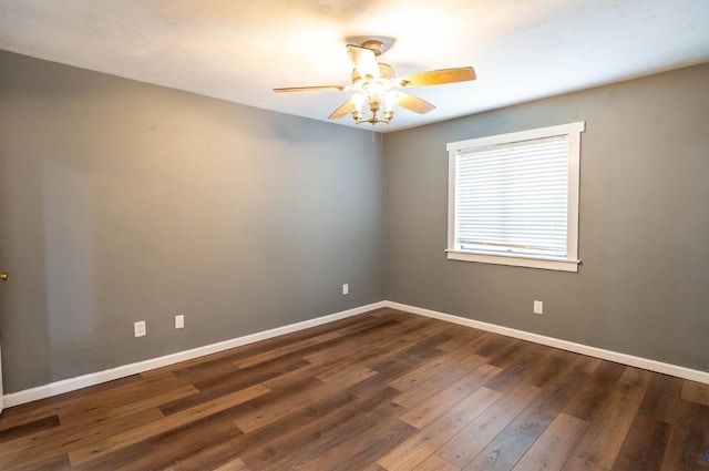 empty room featuring dark wood-type flooring and ceiling fan