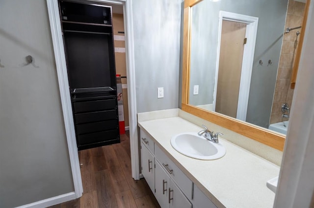 bathroom with vanity, wood-type flooring, and bathing tub / shower combination