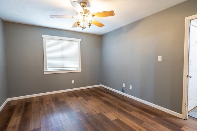 empty room featuring dark wood-type flooring, a healthy amount of sunlight, and ceiling fan