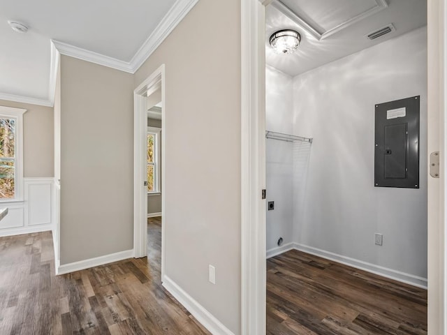 clothes washing area featuring electric panel, ornamental molding, dark hardwood / wood-style flooring, and a healthy amount of sunlight