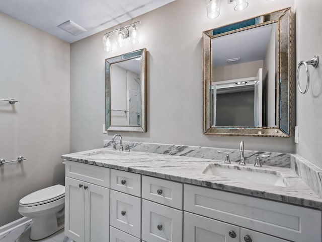 bathroom with toilet and vanity