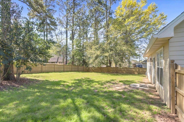 view of yard with a fenced backyard