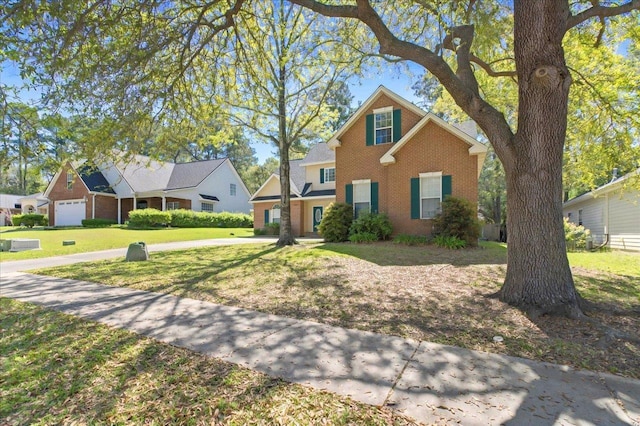 view of front of house with a front yard and brick siding