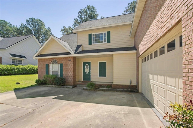 view of front facade with a front lawn and driveway