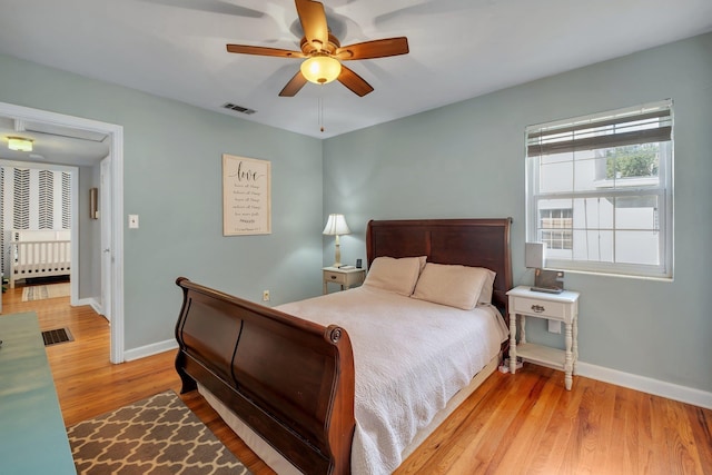 bedroom with light hardwood / wood-style flooring and ceiling fan